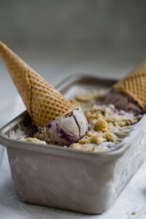 Blueberry pie ice cream upside down in waffle cones.