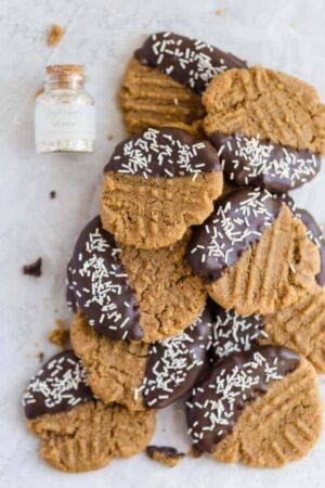 homemade peanut butter cookies dipped in chocolate with white sprinkles.