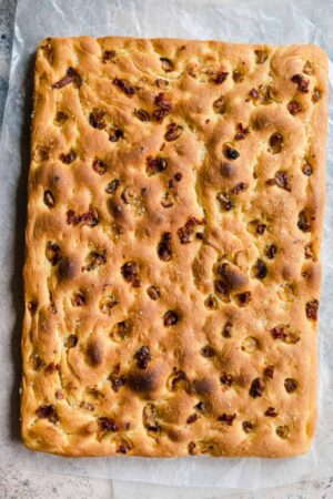 Roasted tomato and garlic focaccia bread before slicing.