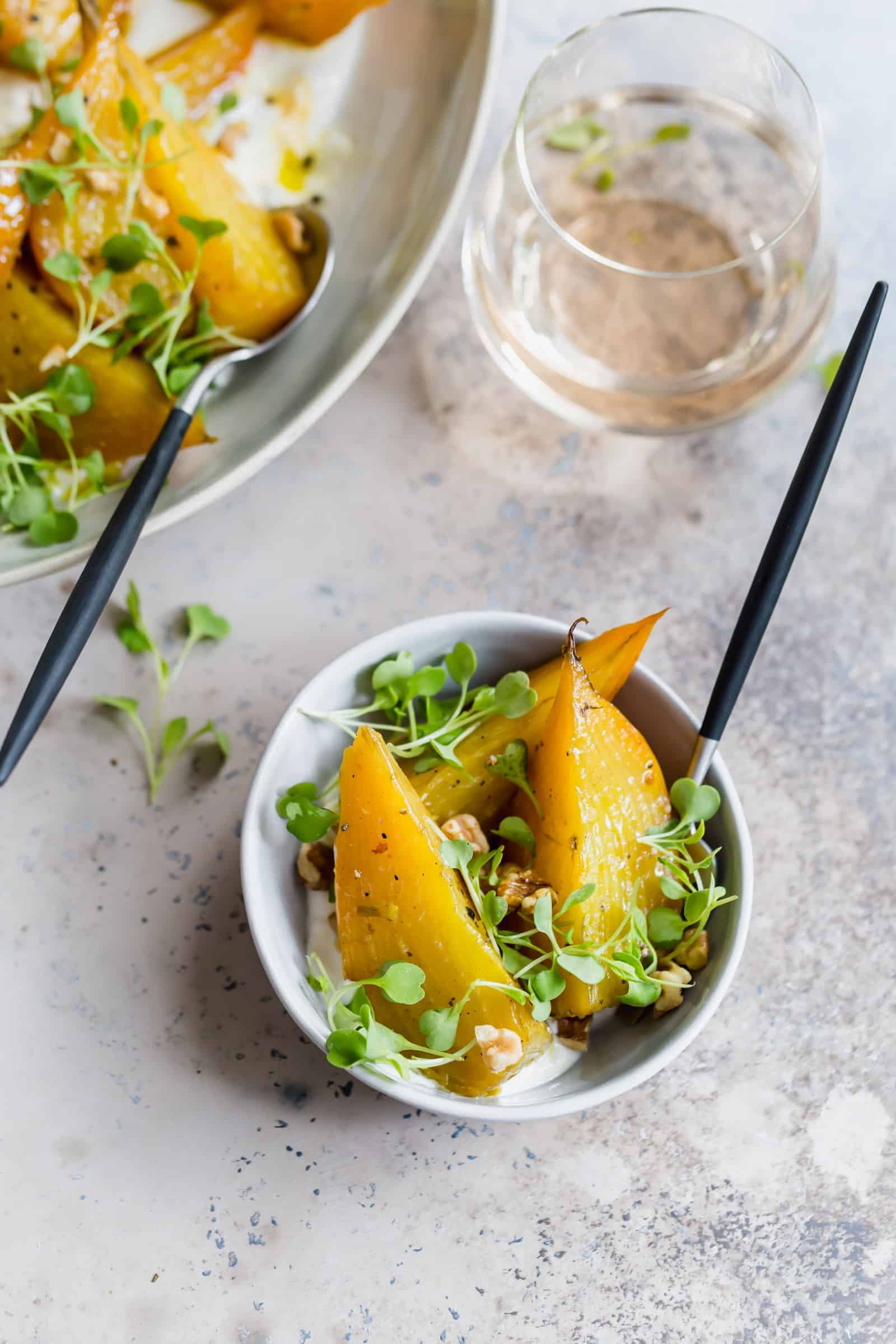 single portion of roasted golden beets with horseradish and arugula