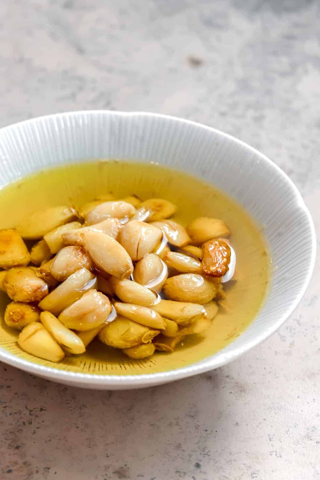 Close up of garlic confit in a bowl