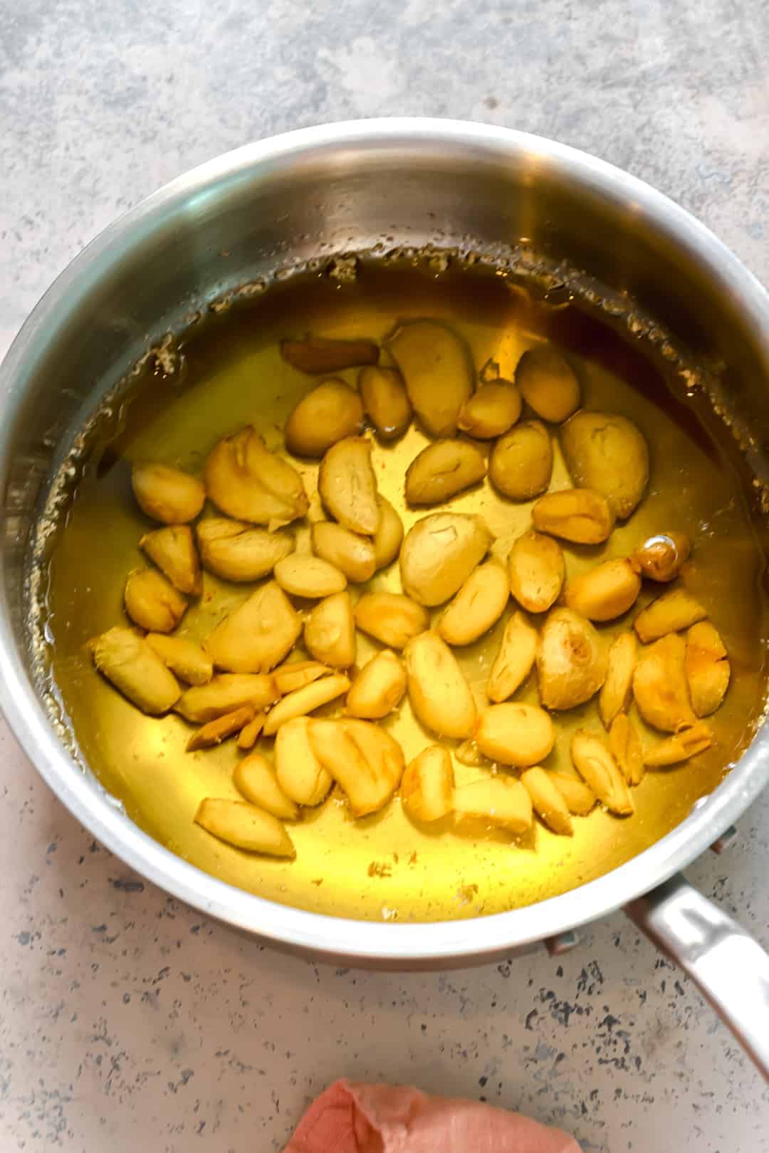 Cooked garlic confit in a sauce pan