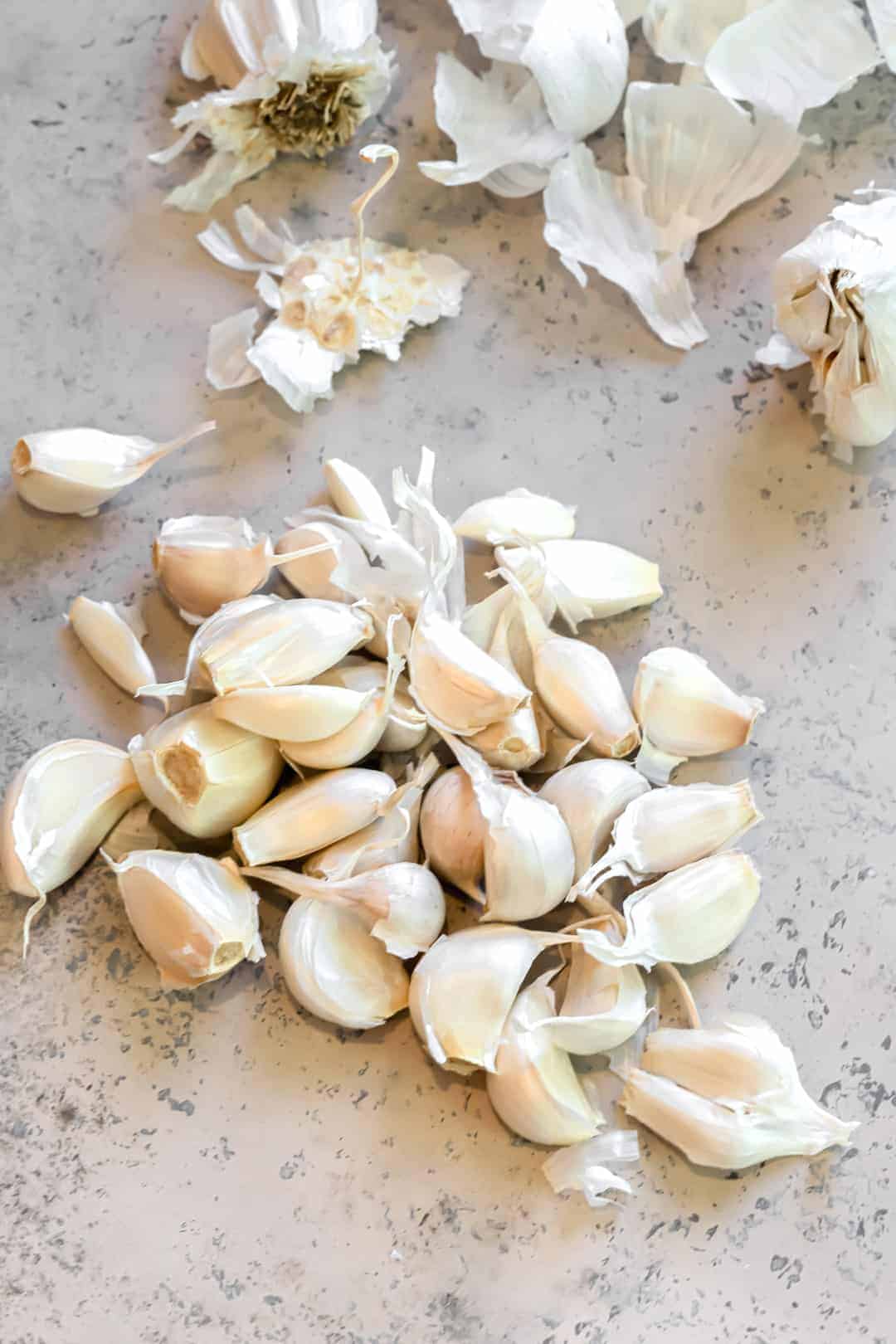 Garlic cloves being peeled for confit