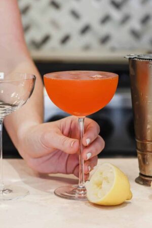 Paper plane cocktail in a coupe glass.