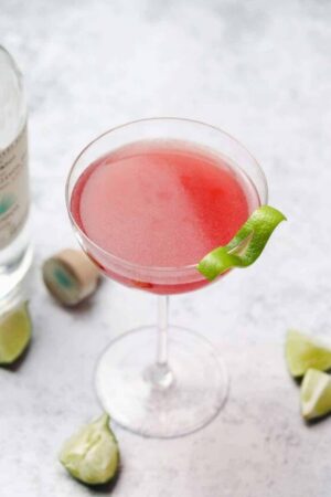 Teqila cocktail with lime in a coupe glass.