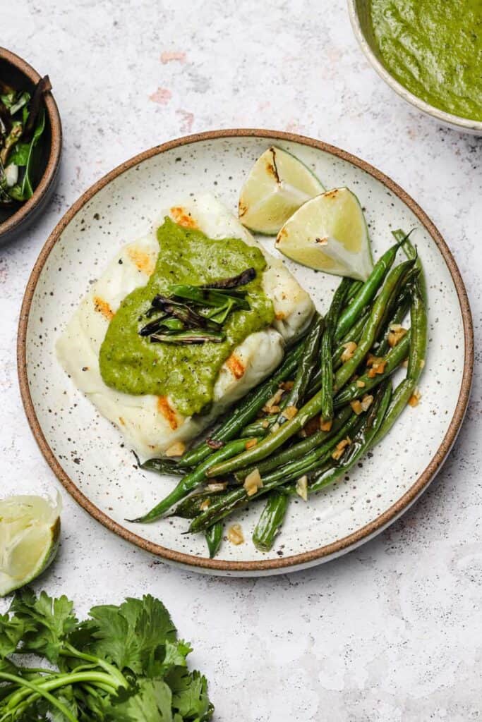Grilled halibut fillet with scallions and blistered haricots verts.