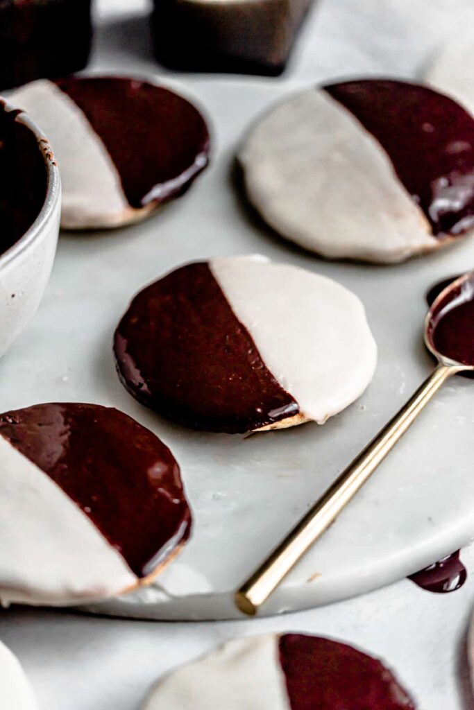 Black and white cookies on a marble tray.