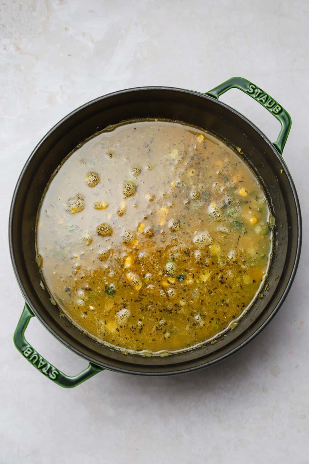 Stock added to a pot of soup.