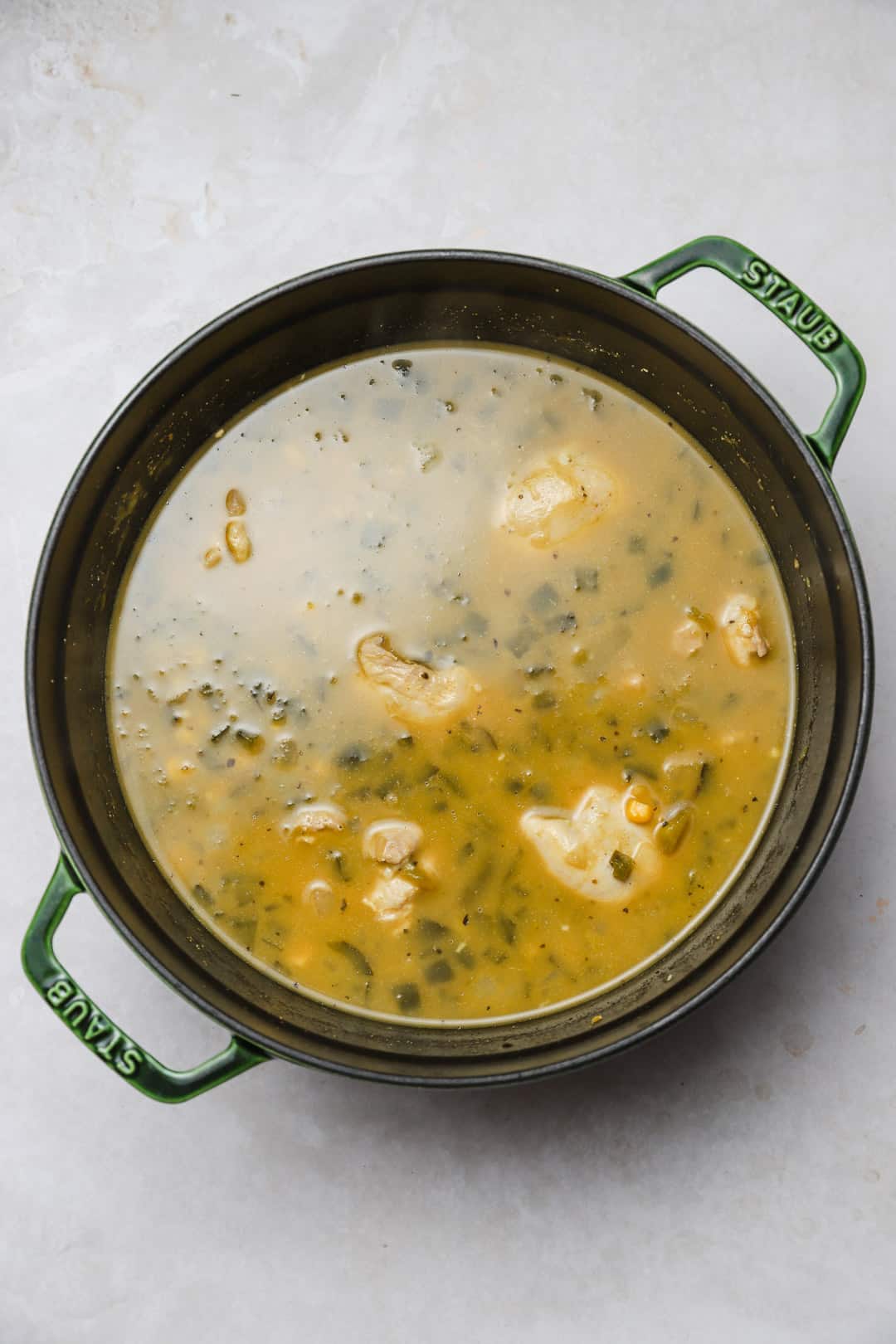 Poaching chicken thighs in soup.