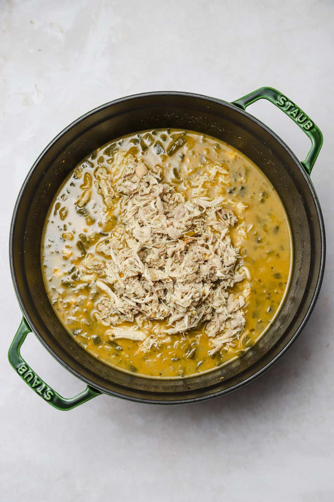 Shredded chicken returned to the pot of green chili.