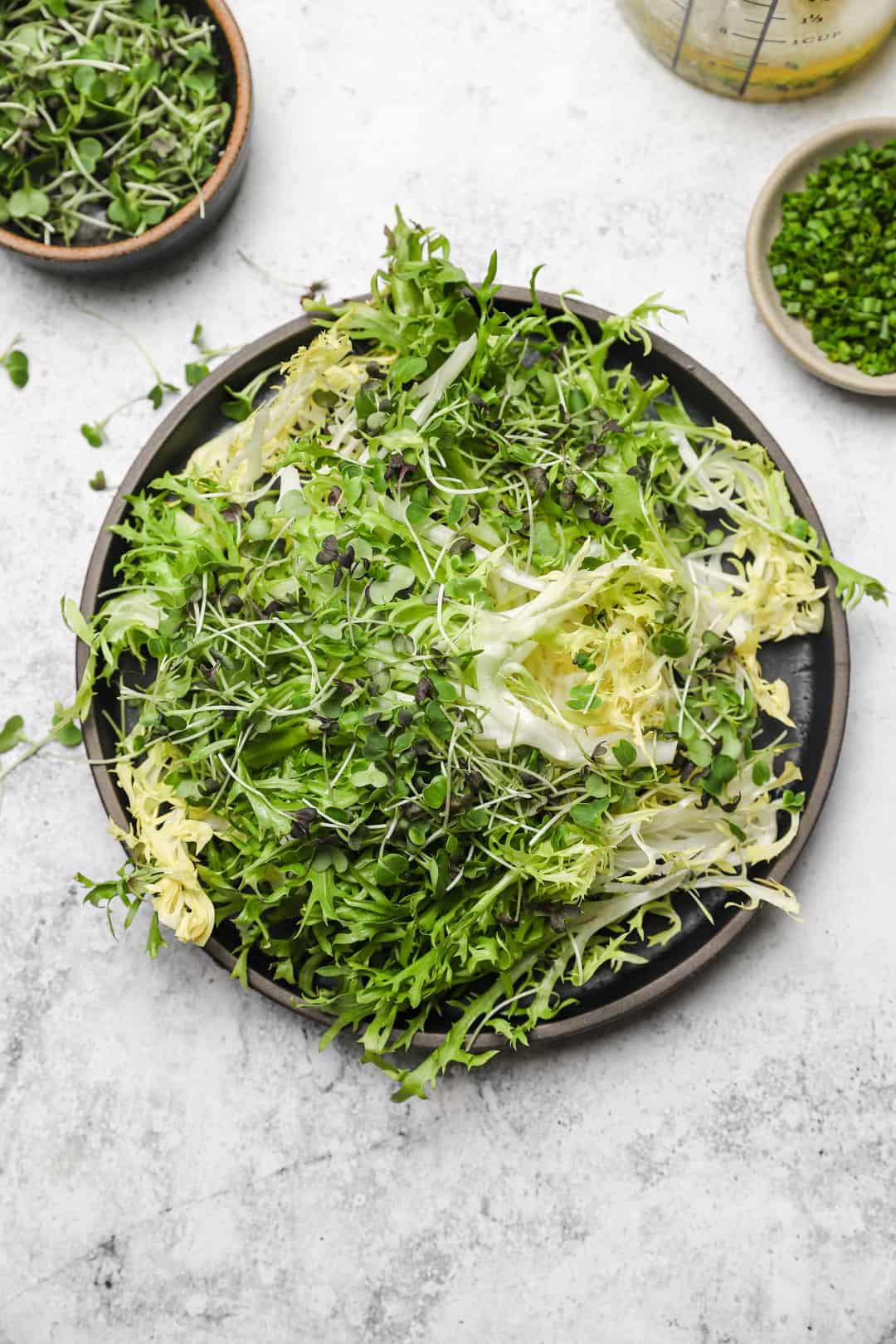 Frisée lettuce and arugula microgreens on a plate
