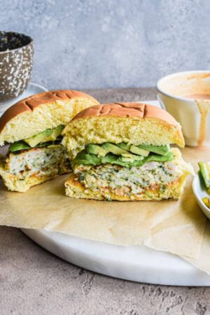 Asian shrimp burgers with spicy mayo cut in half.