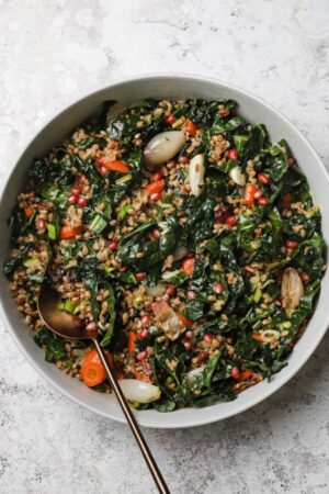 Farro salad with tarragon dressing and roasted vegetables in a bowl.