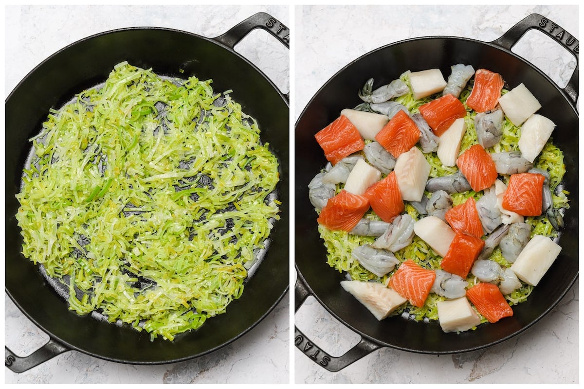 Sautéed leeks and assorted seafood in a cast iron pan.