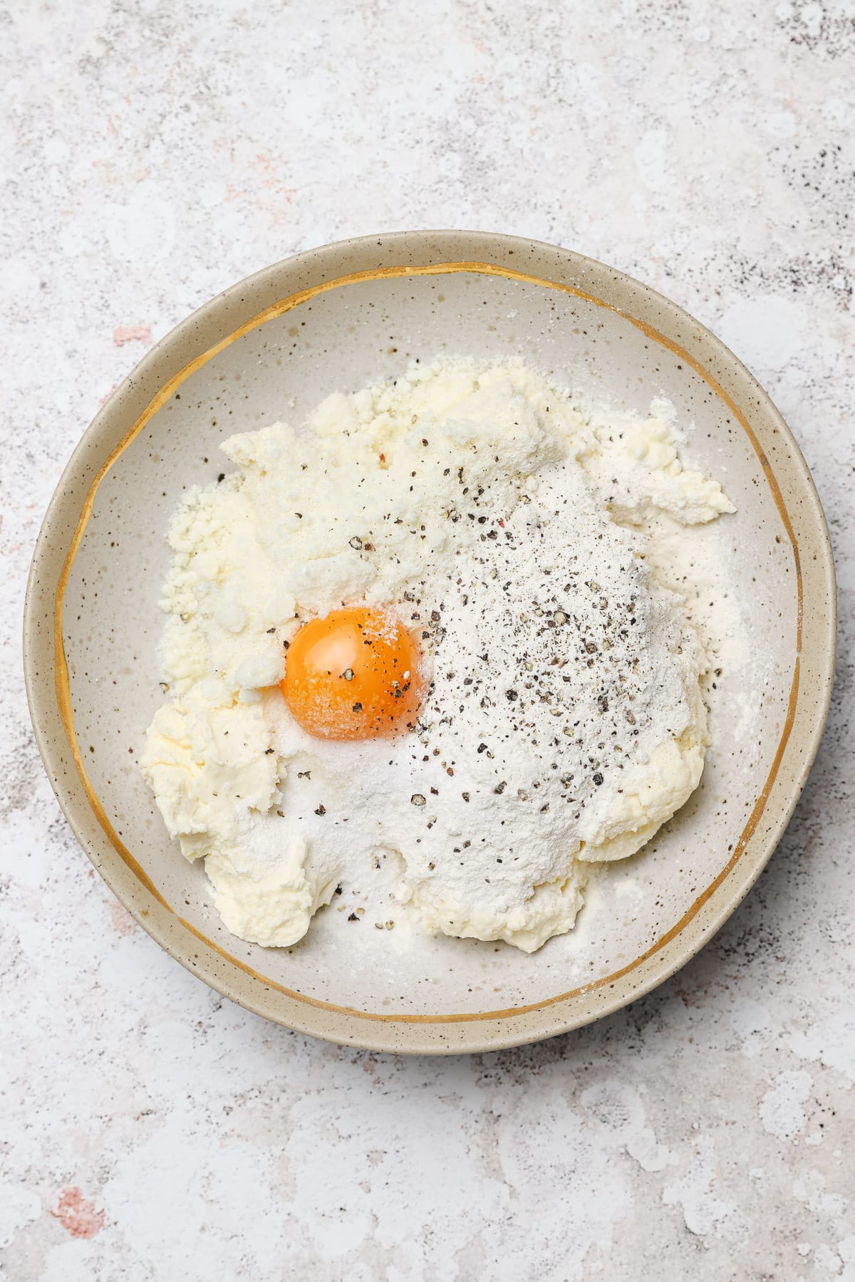 Ricotta gnudi dough ingredients in a bowl.