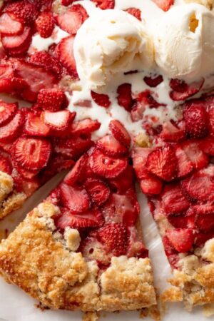 Strawberry galette slice with melted ice cream on top.