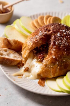 Melted brie cheese wrapped in puff pastry with fig jam and pecans.