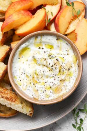 Whipped ricotta with honey and fresh fruit on a plate.
