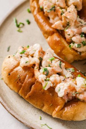 Grilled shrimp tossed with butter mayo and herbs on a split top bun.