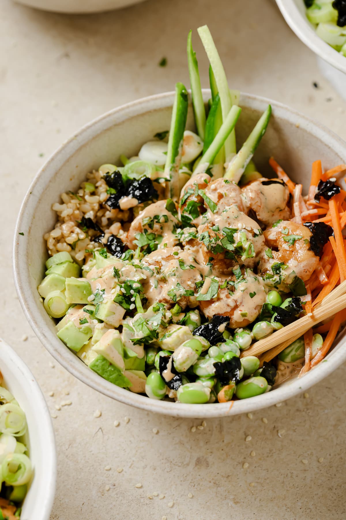 Ginger garlic shrimp over brown rice with vegetables and spicy mayo drizzled on top.