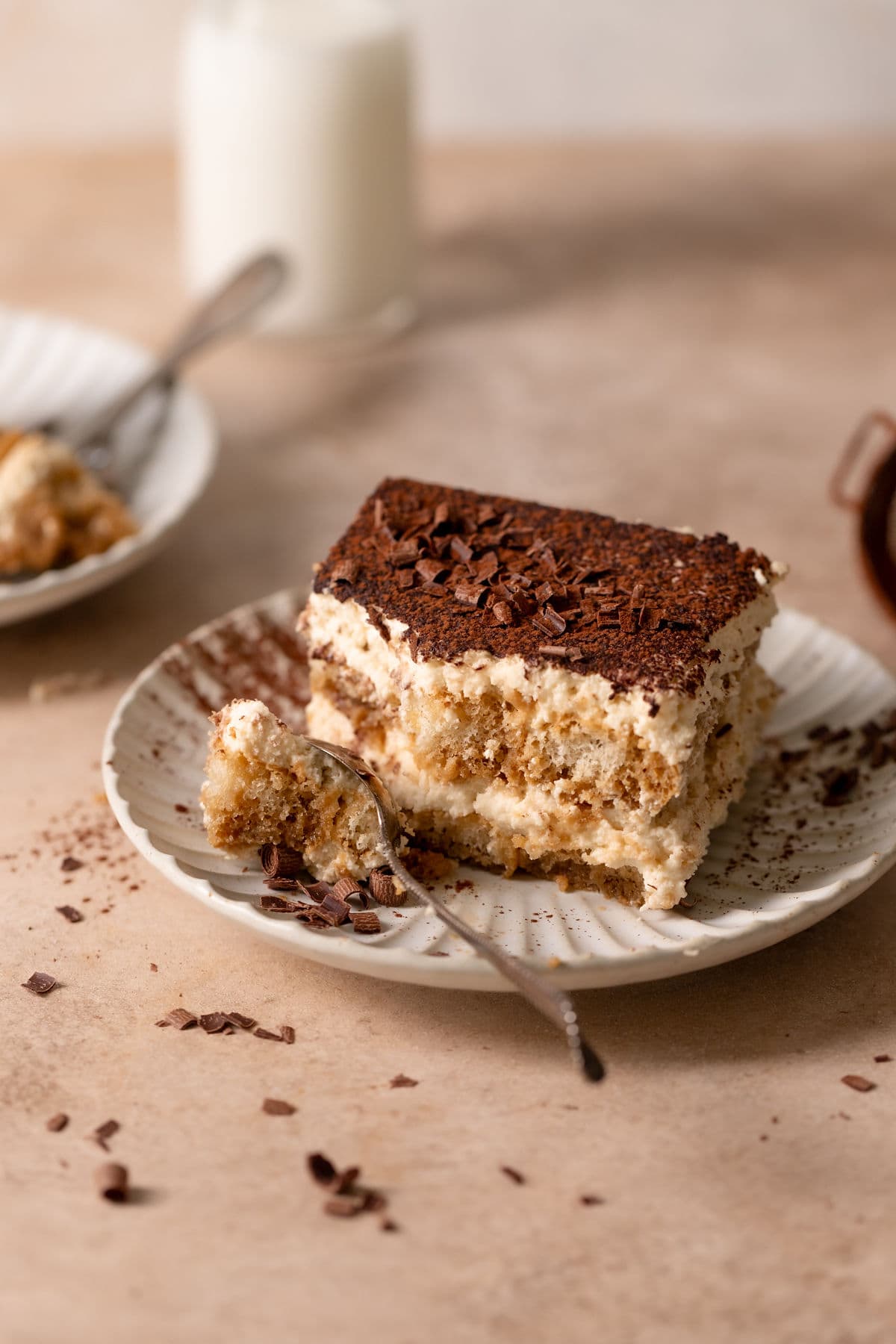 Italian tiramisu on a plate with a spoon.