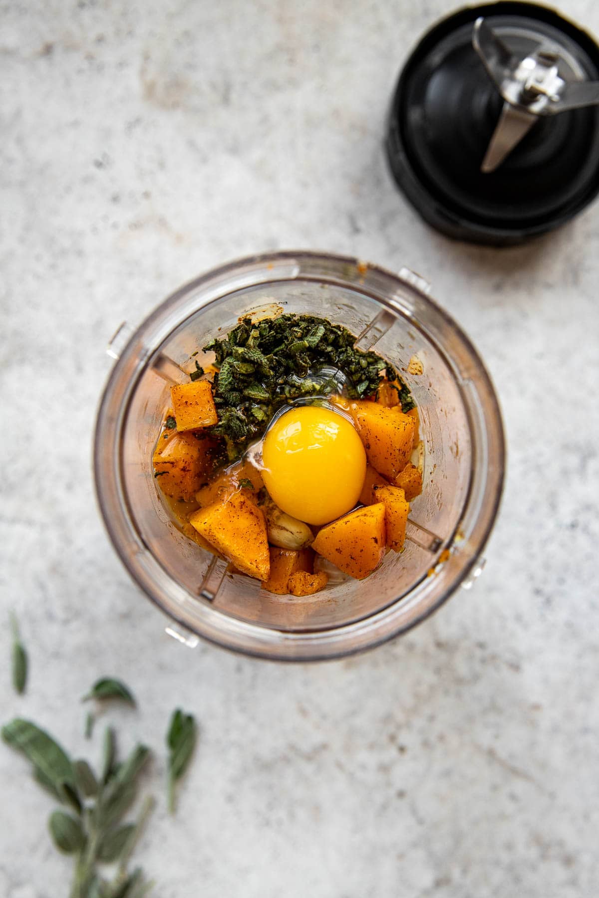 Placing ingredients for butternut squash sauce in a blender.