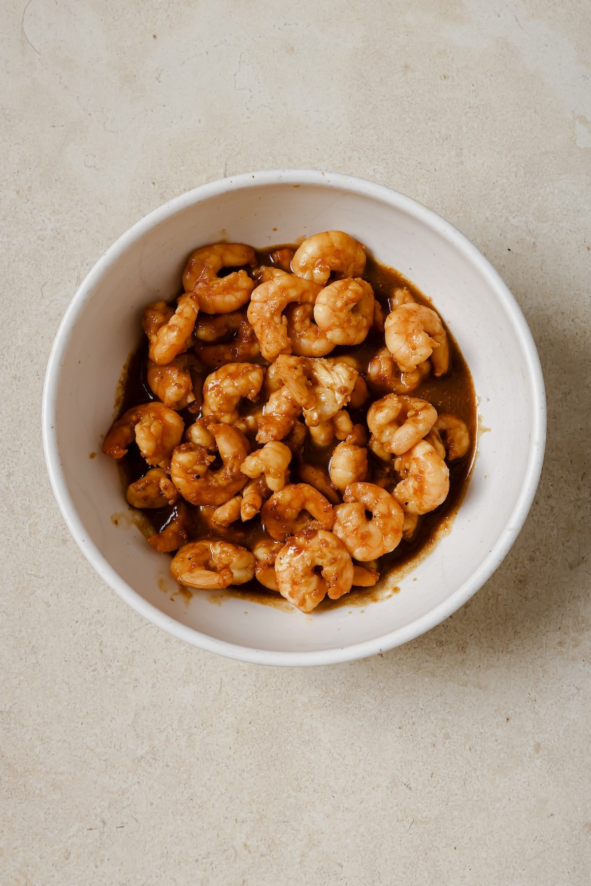 Shrimp marinating in a mixing bowl.