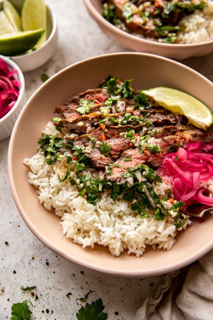 Steak rice bowls with cilantro chimichurri and quick pickled red onions.