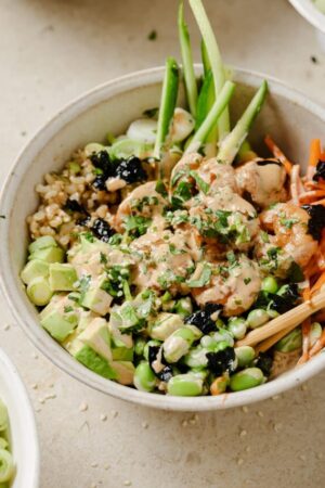 Ginger garlic shrimp over brown rice with vegetables and spicy mayo drizzled on top.