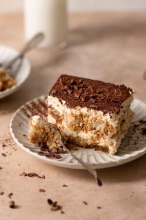 Italian tiramisu on a plate with a spoon.