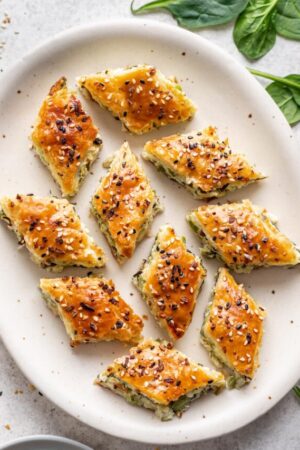 Individual pieces of spinach boureka on a plate.