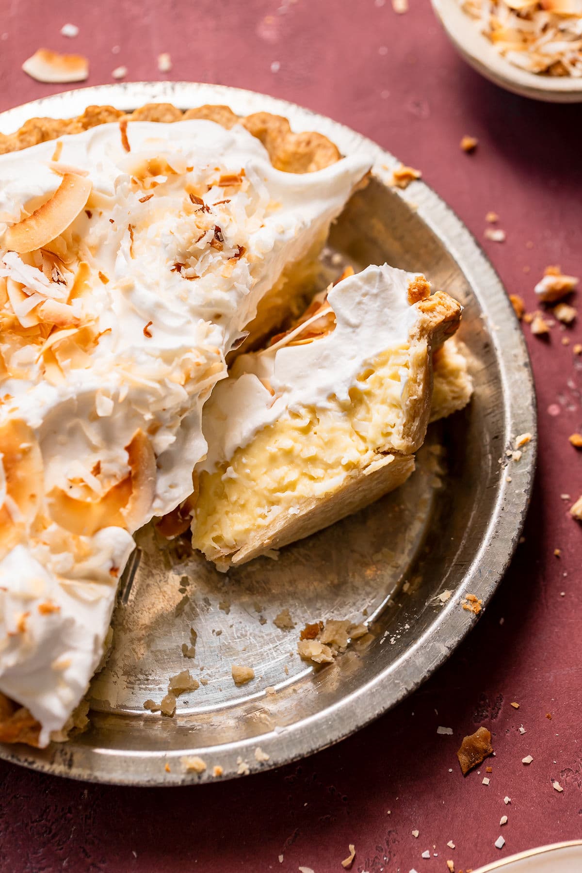 Coconut cream pie slices in a pie dish.