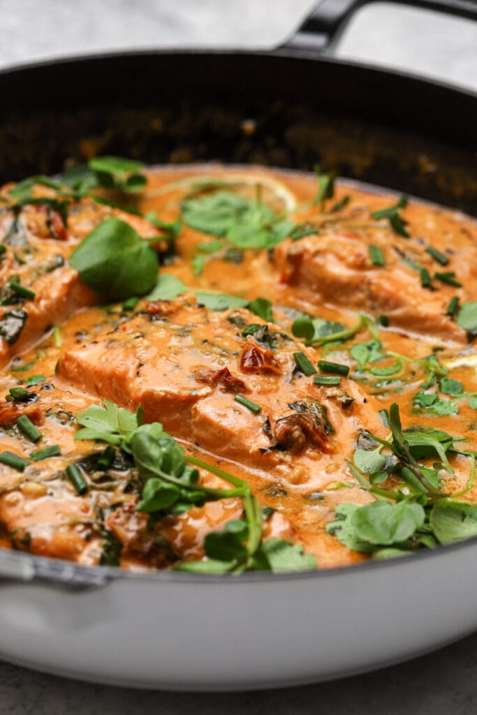 Salmon fillets pan seared then served in creamy coconut milk sauce with sun dried tomatoes.