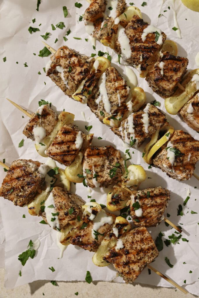 Tender juicy grilled salmon skewers with lemon rounds.