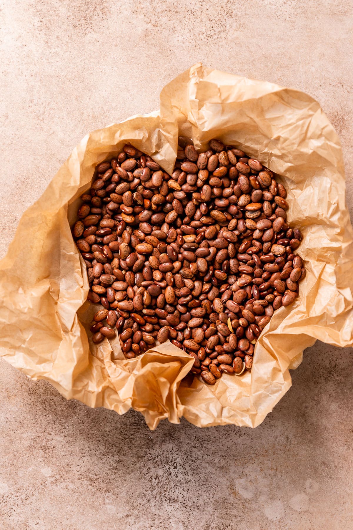 Weighing down a pie shell with beans.