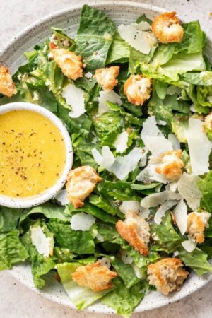 Caesar salad with Caesar vinaigrette and shvaed parmesan.