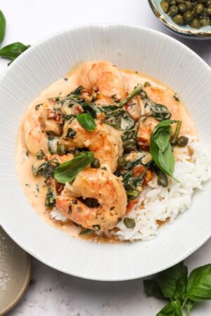 Marry me shrimp over steamed rice with capers and basil.