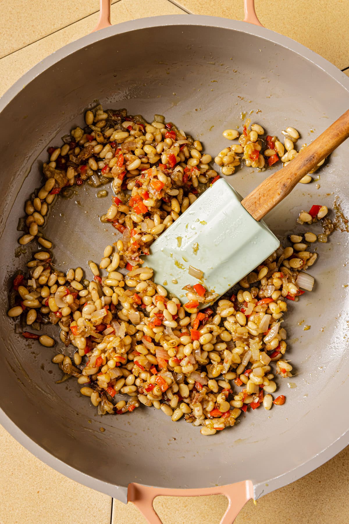 Cook anchovies, chopped garlic, shallot, pine nuts, and chili.