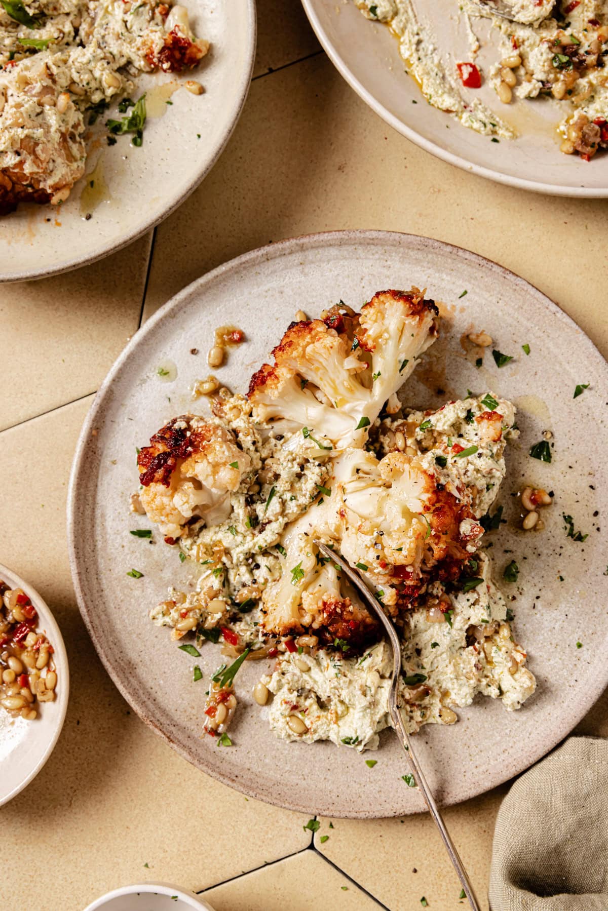Impossibly tender roasted cauliflower on a plate.