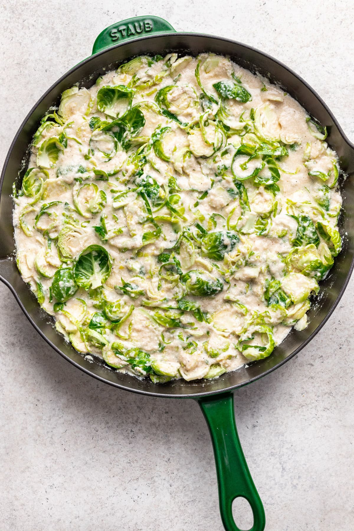 Pour the béchamel sauce over Brussels sprouts.