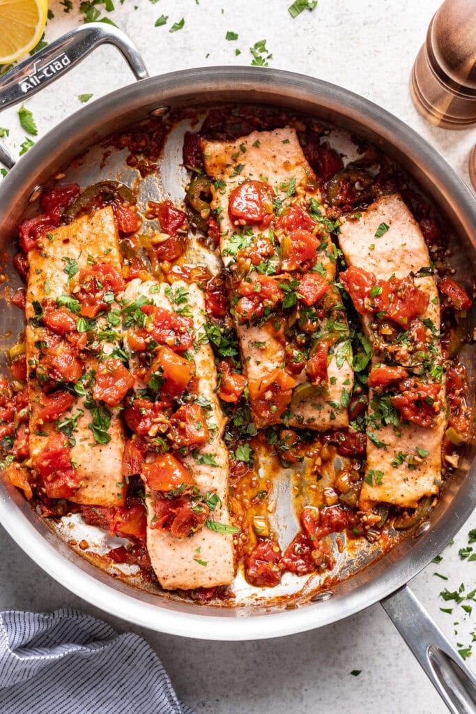 Spoon some of the tomato sauce on top of the salmon filets.