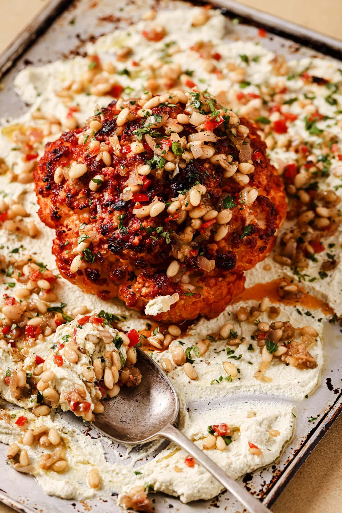 Whole roasted head of cauliflower with pine nuts, anchovies, and ricotta.
