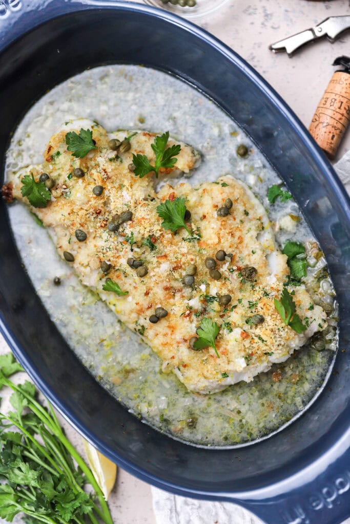 Oven-baked cod with white wine butter sauce.