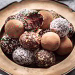 Bite taken out of a chocolate truffle.