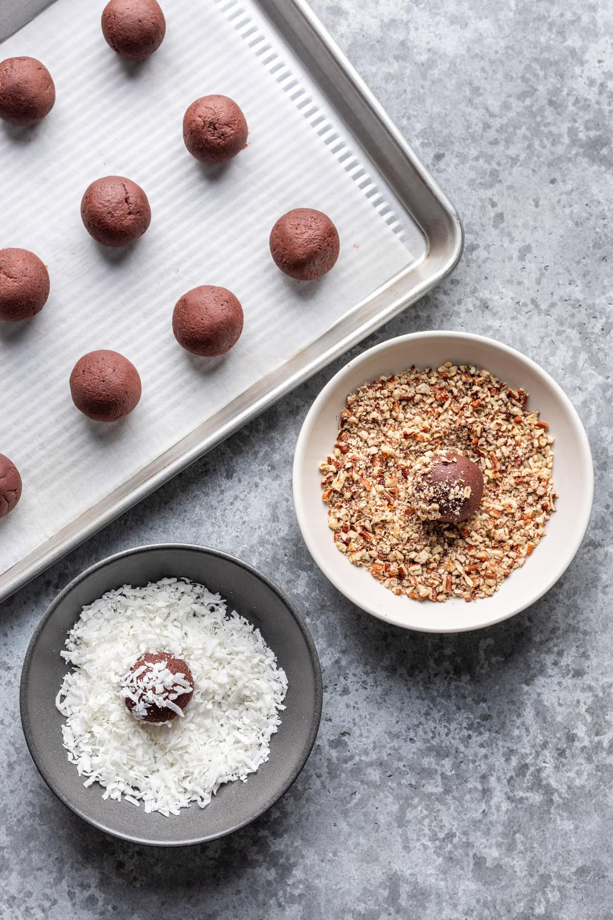 Dipping truffles in shredded coconut and chopped nuts.