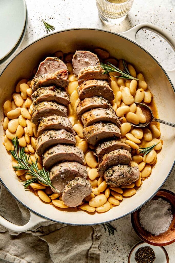 Slice the pork then serve with the butter beans.