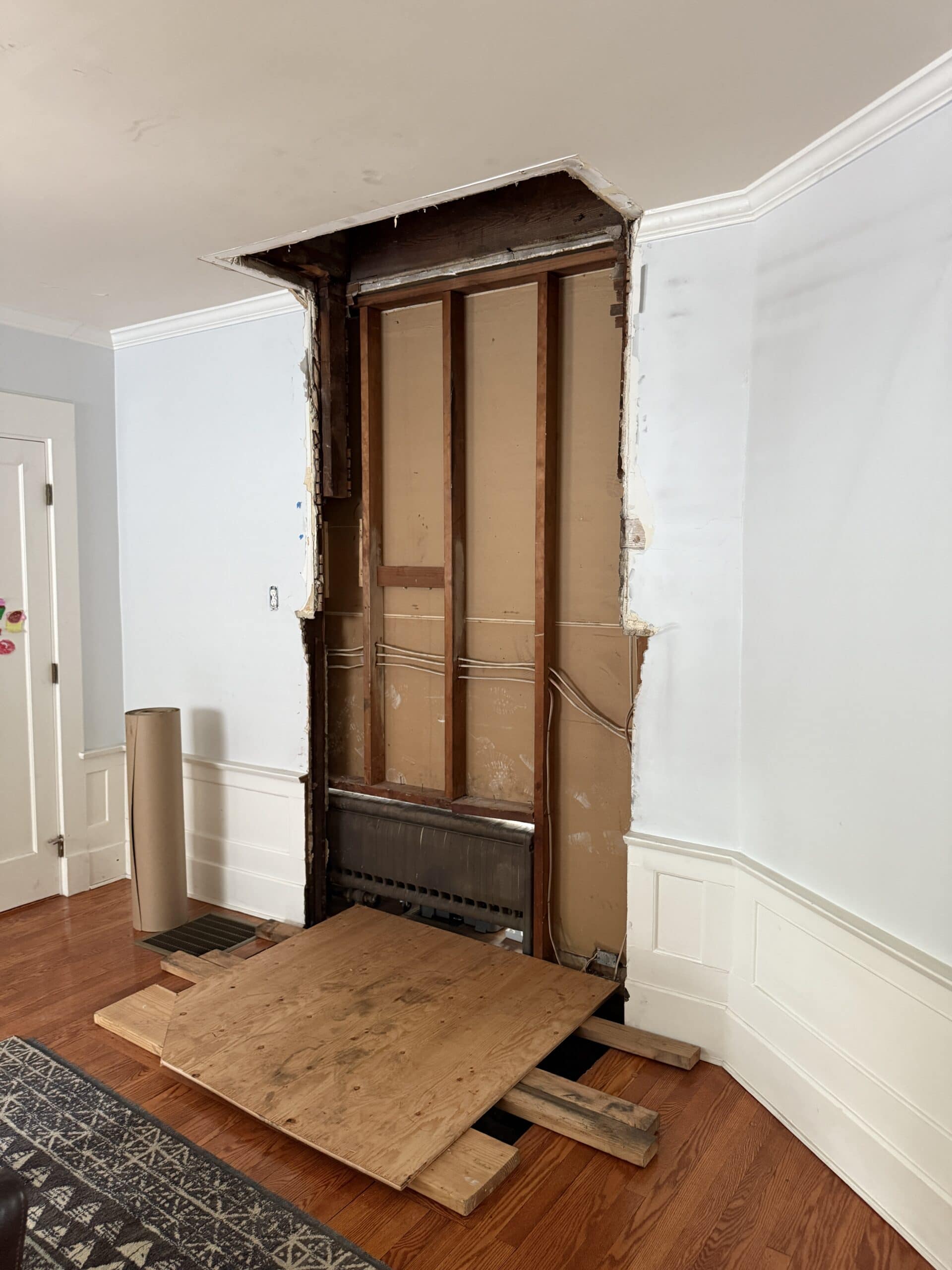 A room with a door frame and a wood floor.