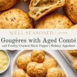 Golden gougères with airy centers are displayed on a platter, surrounded by grated cheese and cracked pepper. Some gougères are broken open, revealing their fluffy, hollow interiors. Text describes the dish as a holiday appetizer.